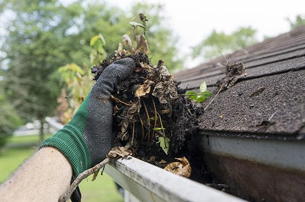 gutter cleaning involves using ladders and specialized tools to safely remove debris from the gutters